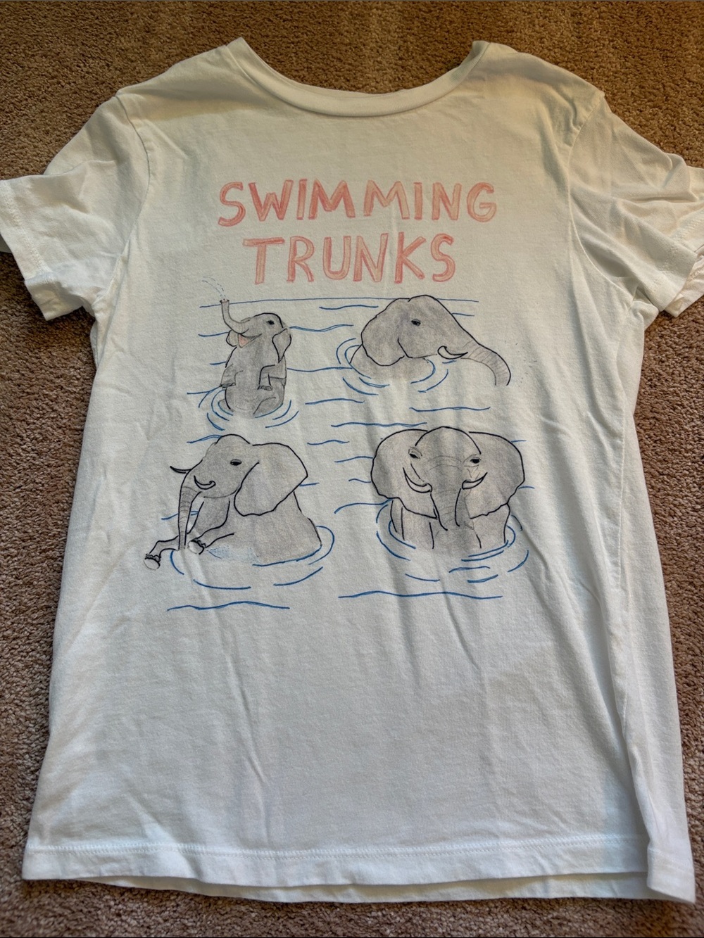 White 'Swimming Trunks' Graphic Tee with Pink Text and Elephant Design